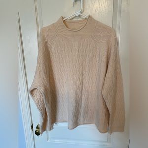 Cashmere cable knit sweater with a roll neck